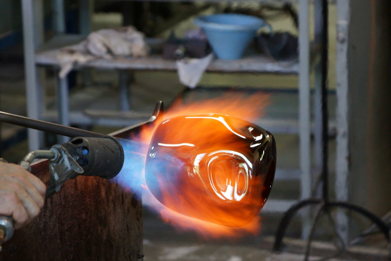 Molten glass being shaped at the bench